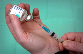 CDC Clinic Chief Nurse, Lee Ann Jean-Louis, extracting a dose of Influenza Virus Vaccine.